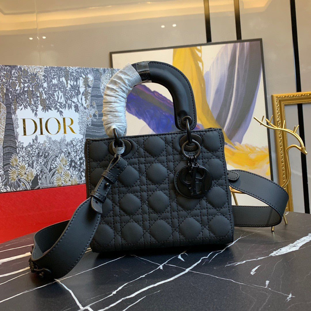 black Dior Lady Dior bag in cannage lambskin leather.