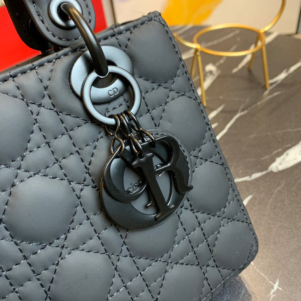 black Dior Lady Dior bag in cannage lambskin leather.