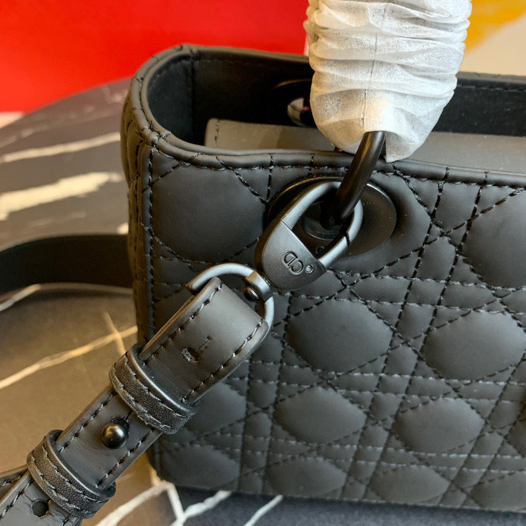 black Dior Lady Dior bag in cannage lambskin leather.