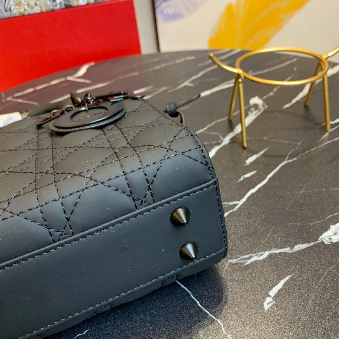 black Dior Lady Dior bag in cannage lambskin leather.