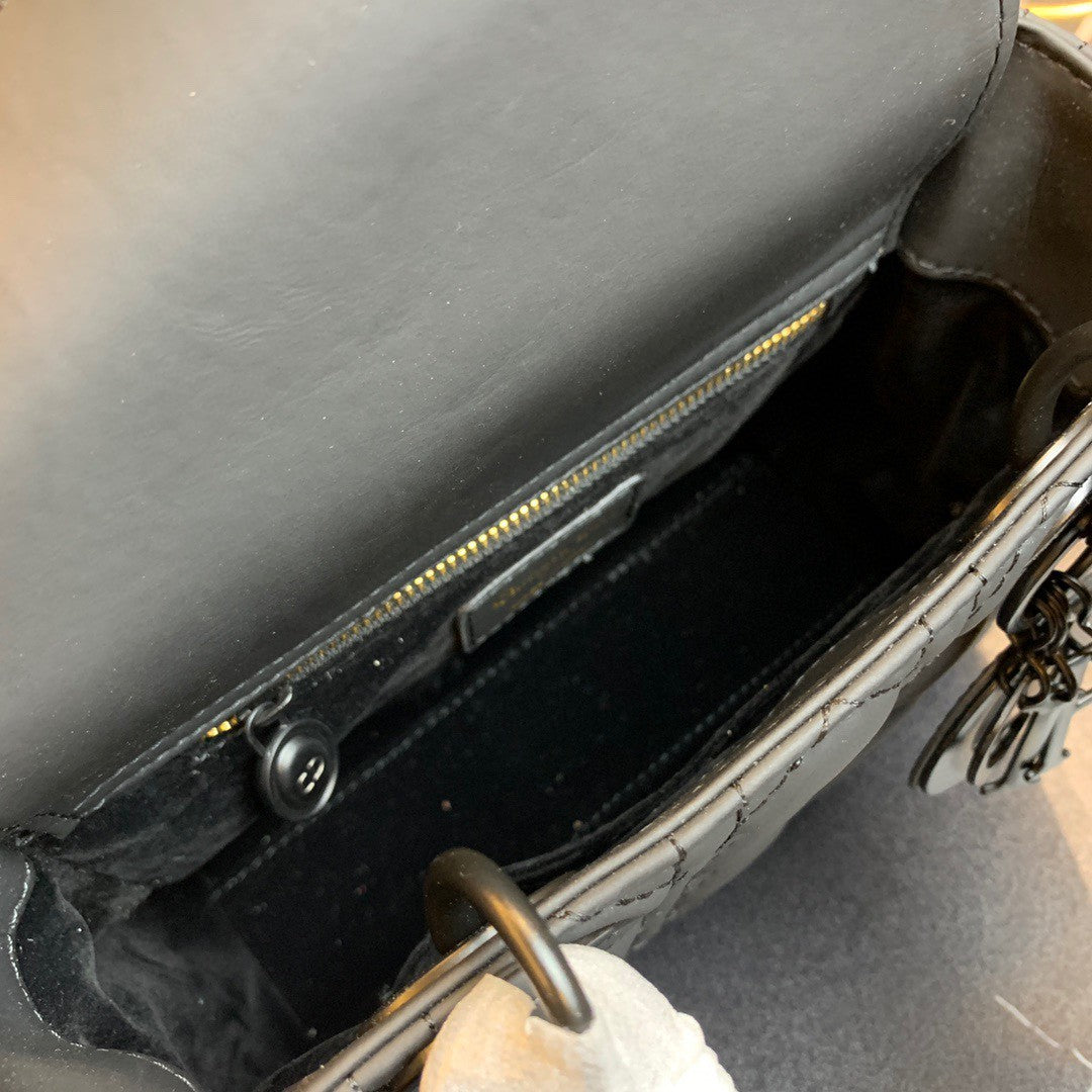 black Dior Lady Dior bag in cannage lambskin leather.
