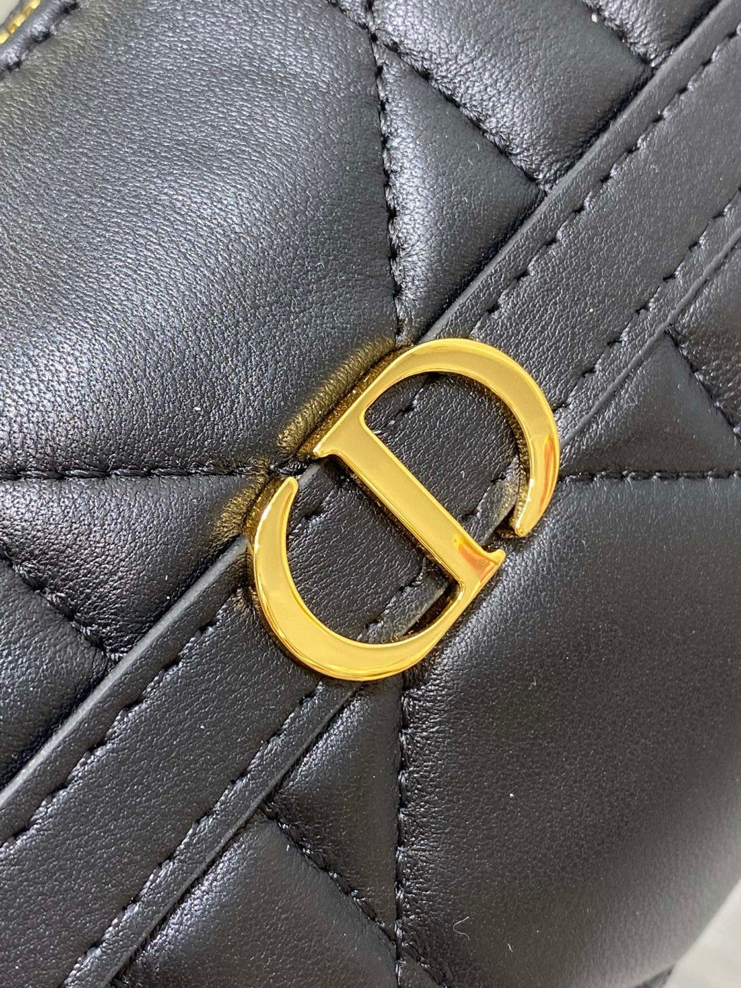 Dior Miss Caro mini hobo shoulder bag in black Macrocannage lambskin with a gold-finish metal CD signature and chain strap.