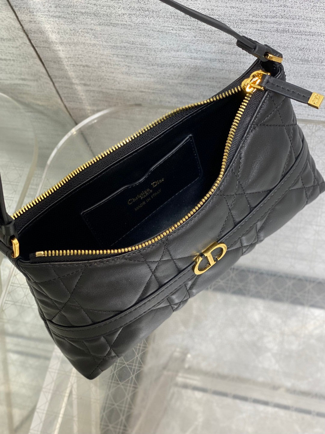 Dior Miss Caro mini hobo shoulder bag in black Macrocannage lambskin with a gold-finish metal CD signature and chain strap.