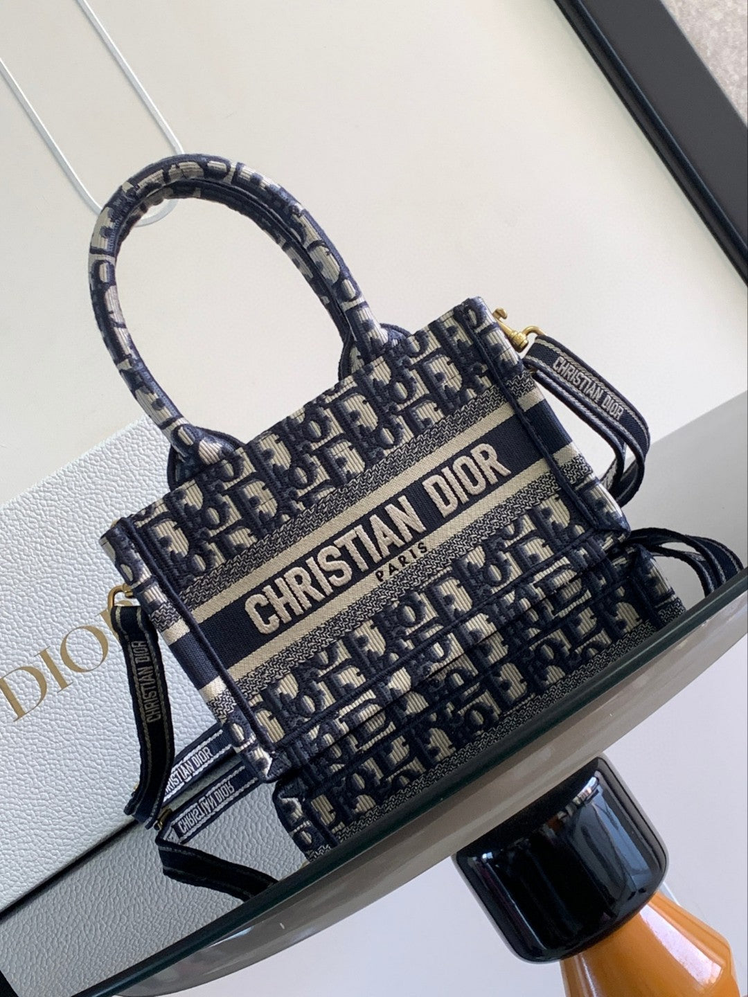 Mini or East-West Dior Book Tote with a strap, featuring blue Dior Oblique embroidery and calfskin