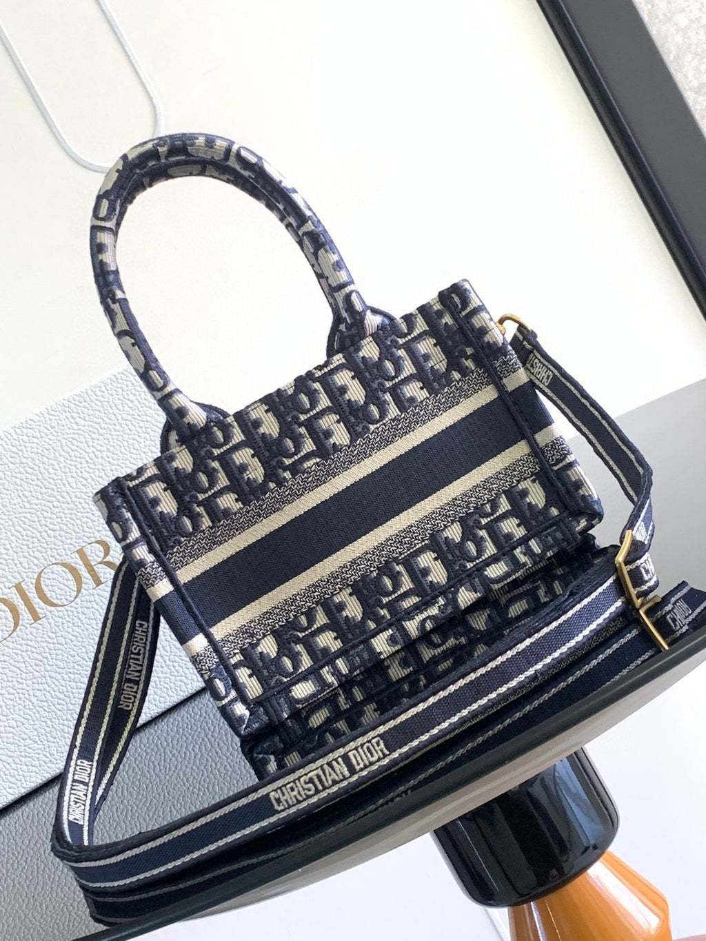 Mini or East-West Dior Book Tote with a strap, featuring blue Dior Oblique embroidery and calfskin