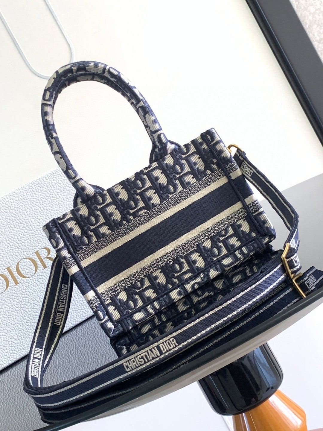 Mini or East-West Dior Book Tote with a strap, featuring blue Dior Oblique embroidery and calfskin