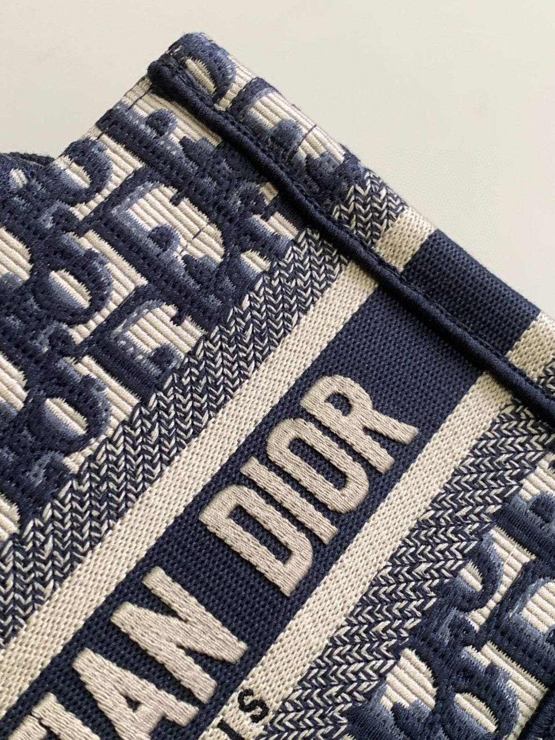 Mini or East-West Dior Book Tote with a strap, featuring blue Dior Oblique embroidery and calfskin