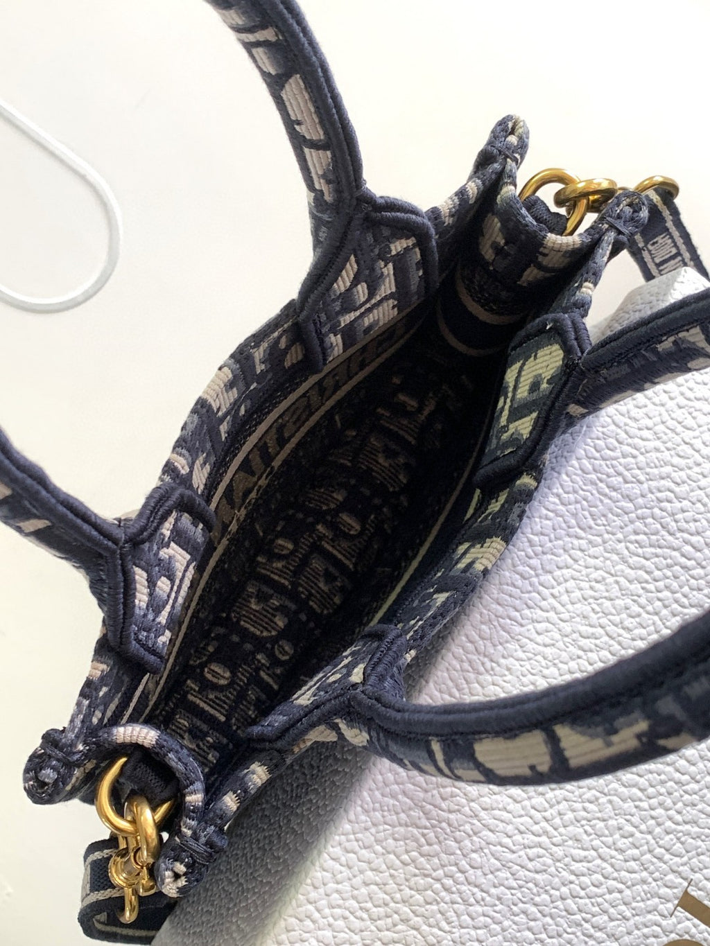 Mini or East-West Dior Book Tote with a strap, featuring blue Dior Oblique embroidery and calfskin