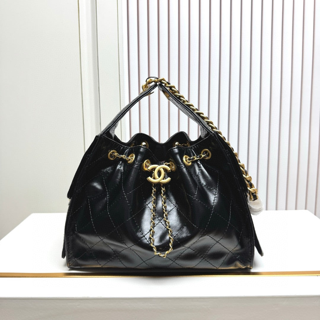 Chanel 25 small hobo bag in black shiny crumpled calfskin leather with mixed metal hardware