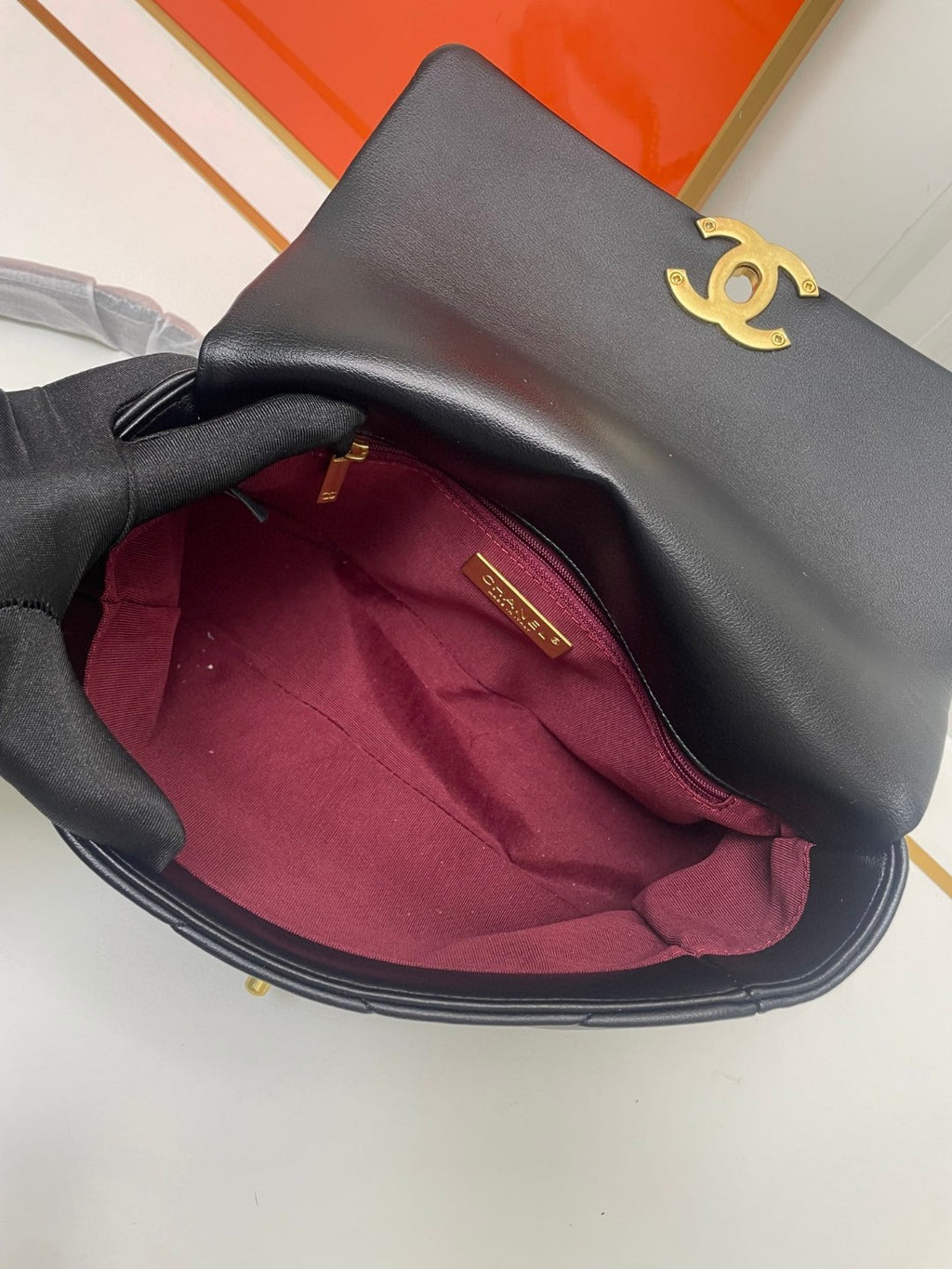 black Chanel 19 flap bag in lambskin with gold-tone