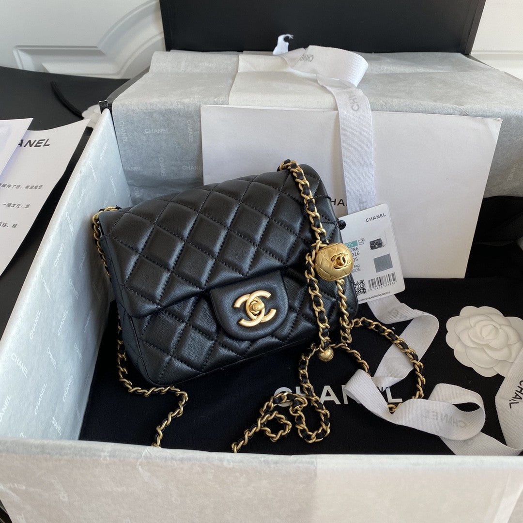 black quilted leather Chanel Mini Flap Bag with a gold-tone chain strap