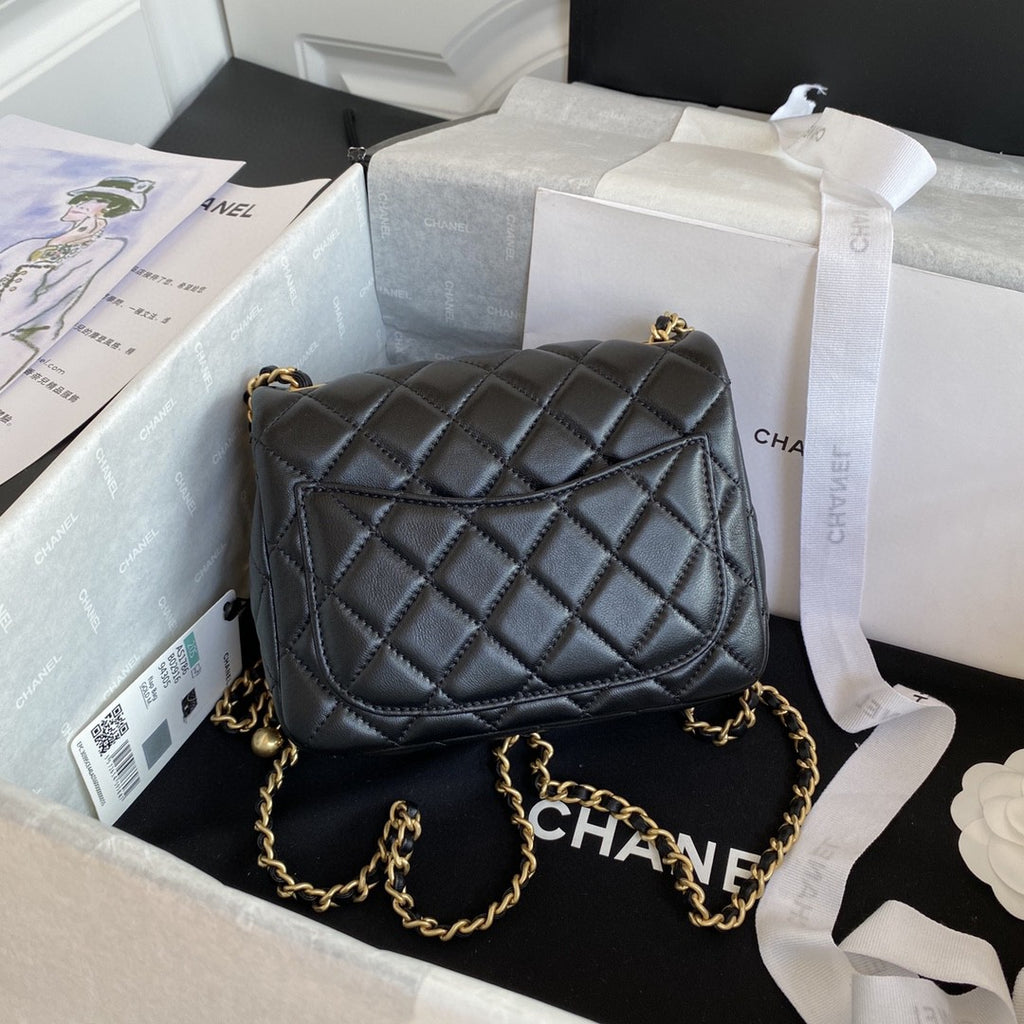 black quilted leather Chanel Mini Flap Bag with a gold-tone chain strap