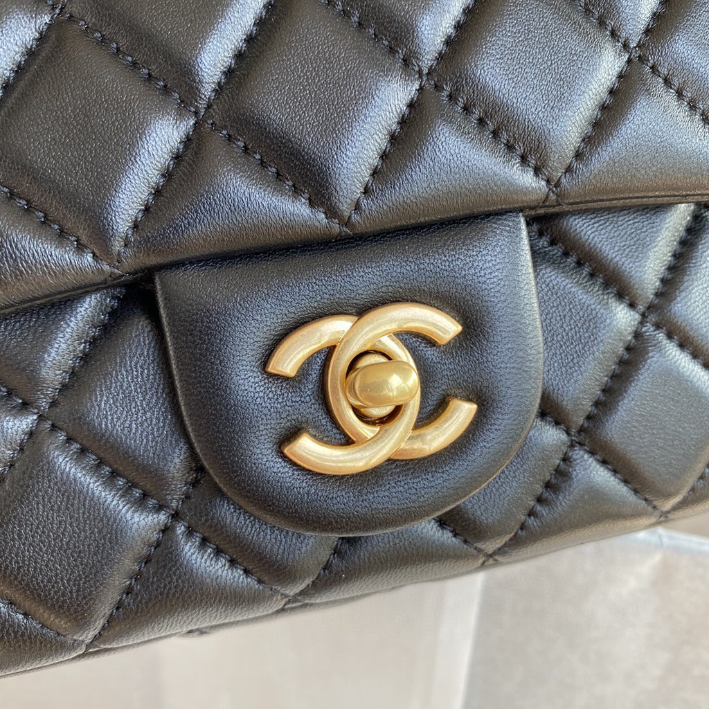 black quilted leather Chanel Mini Flap Bag with a gold-tone chain strap