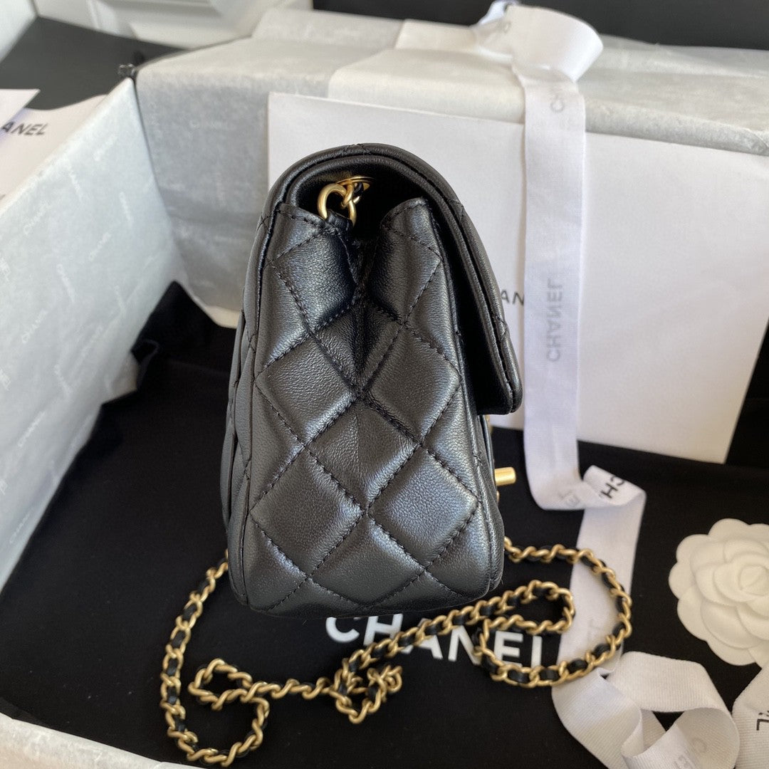 black quilted leather Chanel Mini Flap Bag with a gold-tone chain strap