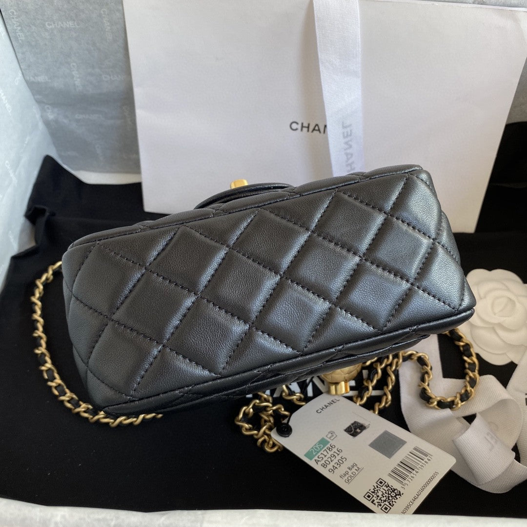 black quilted leather Chanel Mini Flap Bag with a gold-tone chain strap