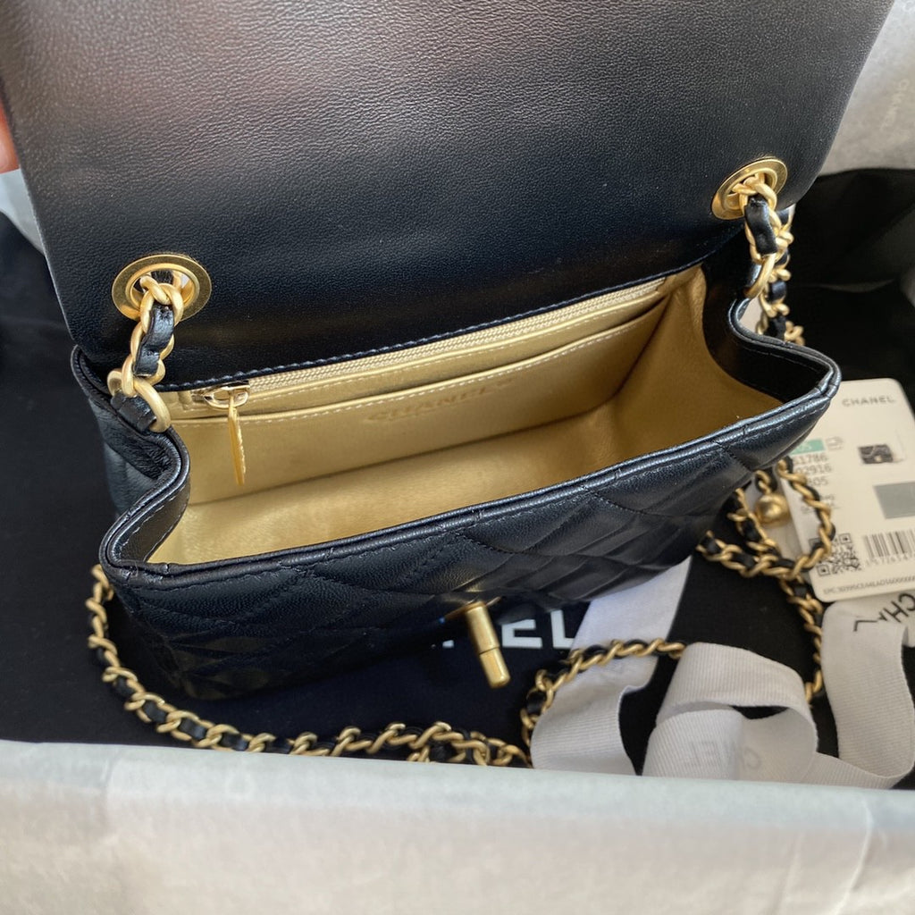 black quilted leather Chanel Mini Flap Bag with a gold-tone chain strap