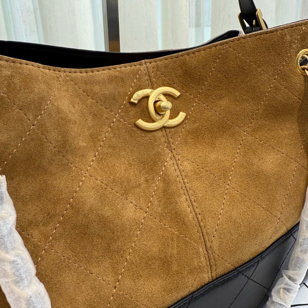 Chanel 25A Two-Tone Shopping Bag in beige suede, black calfskin, and gold-tone metal hardware
