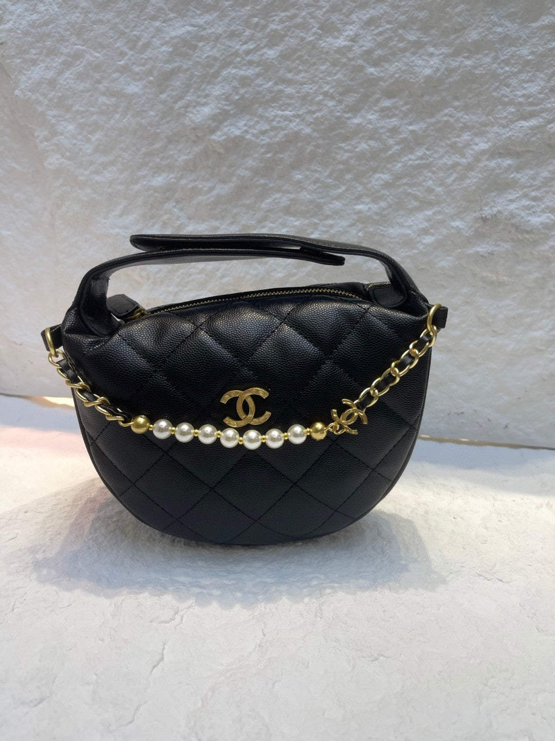 Chanel Spring-Summer 2025 (25S) pouch in black grained calfskin leather with imitation pearl and gold-tone metal hardware