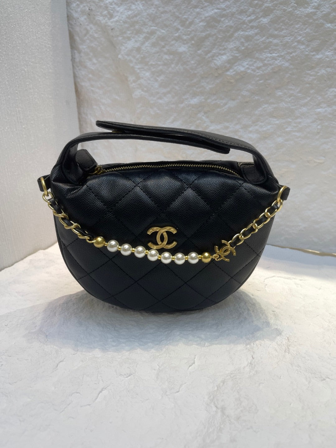 Chanel Spring-Summer 2025 (25S) pouch in black grained calfskin leather with imitation pearl and gold-tone metal hardware
