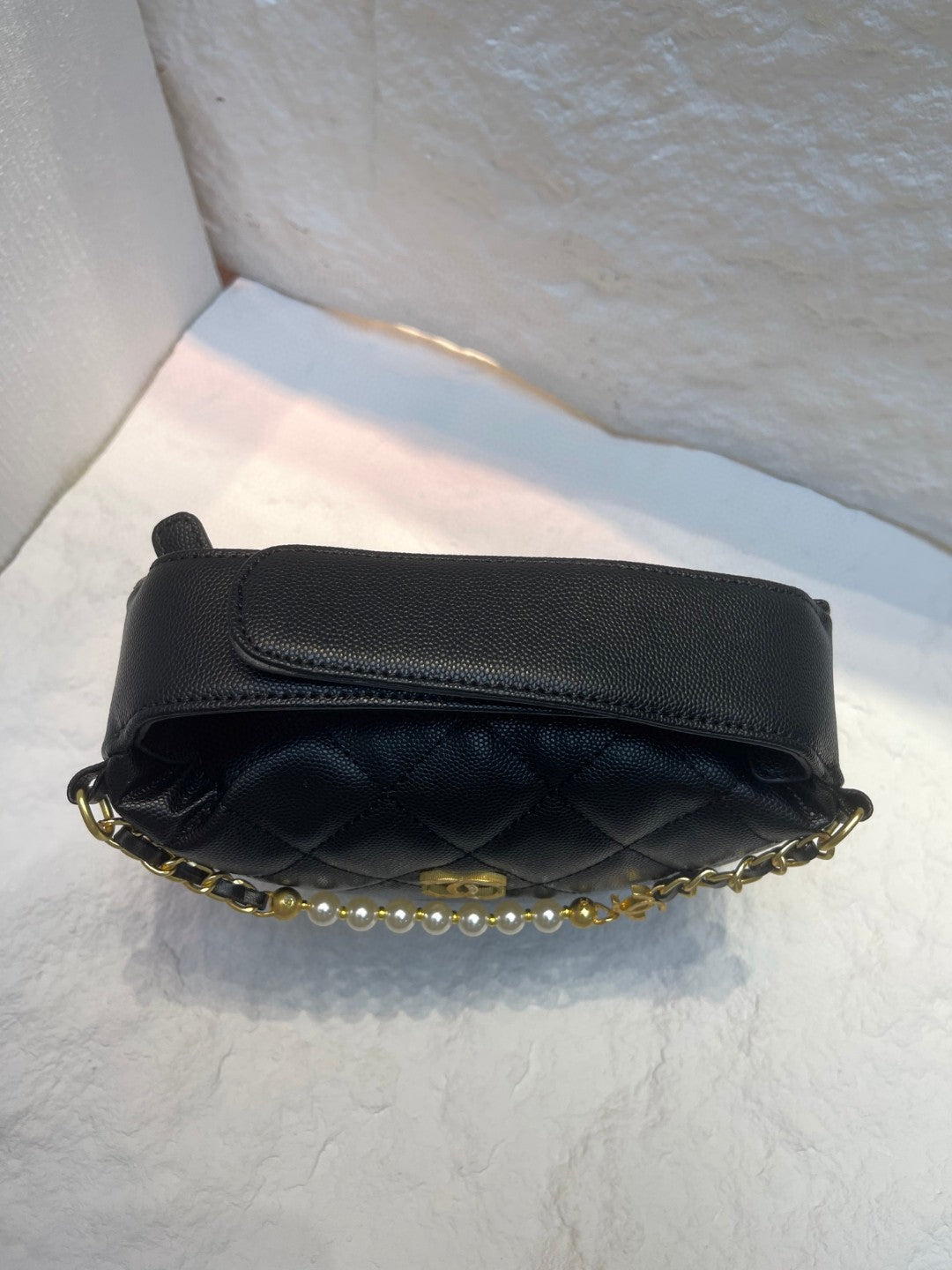 Chanel Spring-Summer 2025 (25S) pouch in black grained calfskin leather with imitation pearl and gold-tone metal hardware