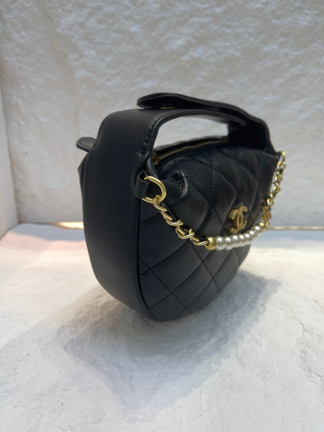 Chanel Spring-Summer 2025 (25S) pouch in black grained calfskin leather with imitation pearl and gold-tone metal hardware