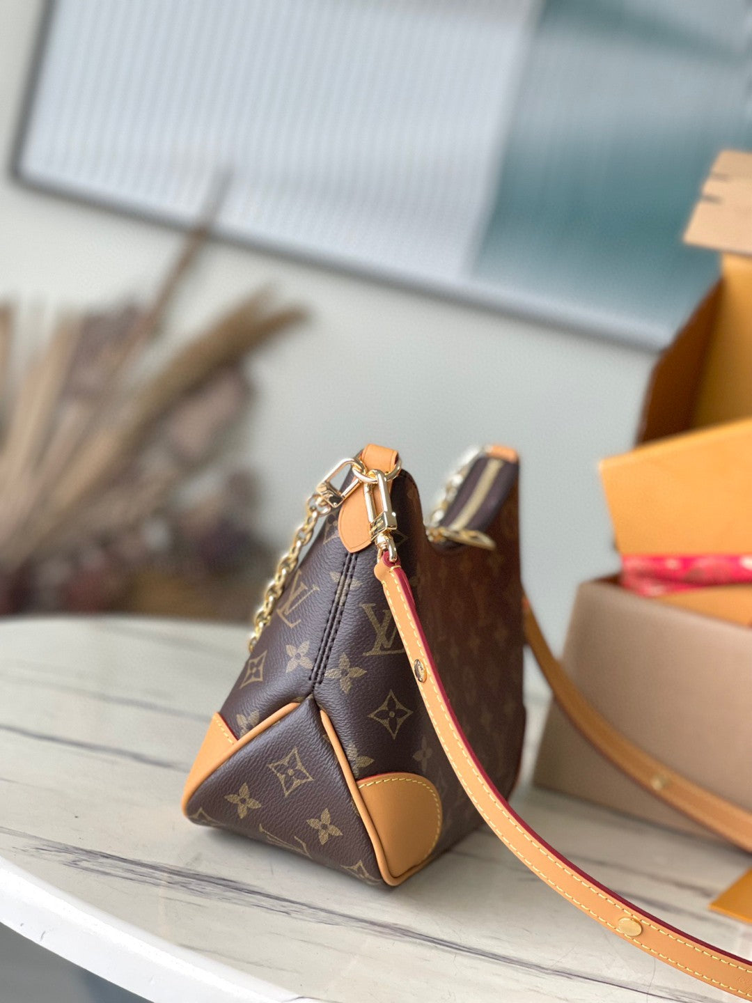 Louis Vuitton Boulogne PM bag in classic Monogram canvas with natural cowhide leather trim and gold-color hardware