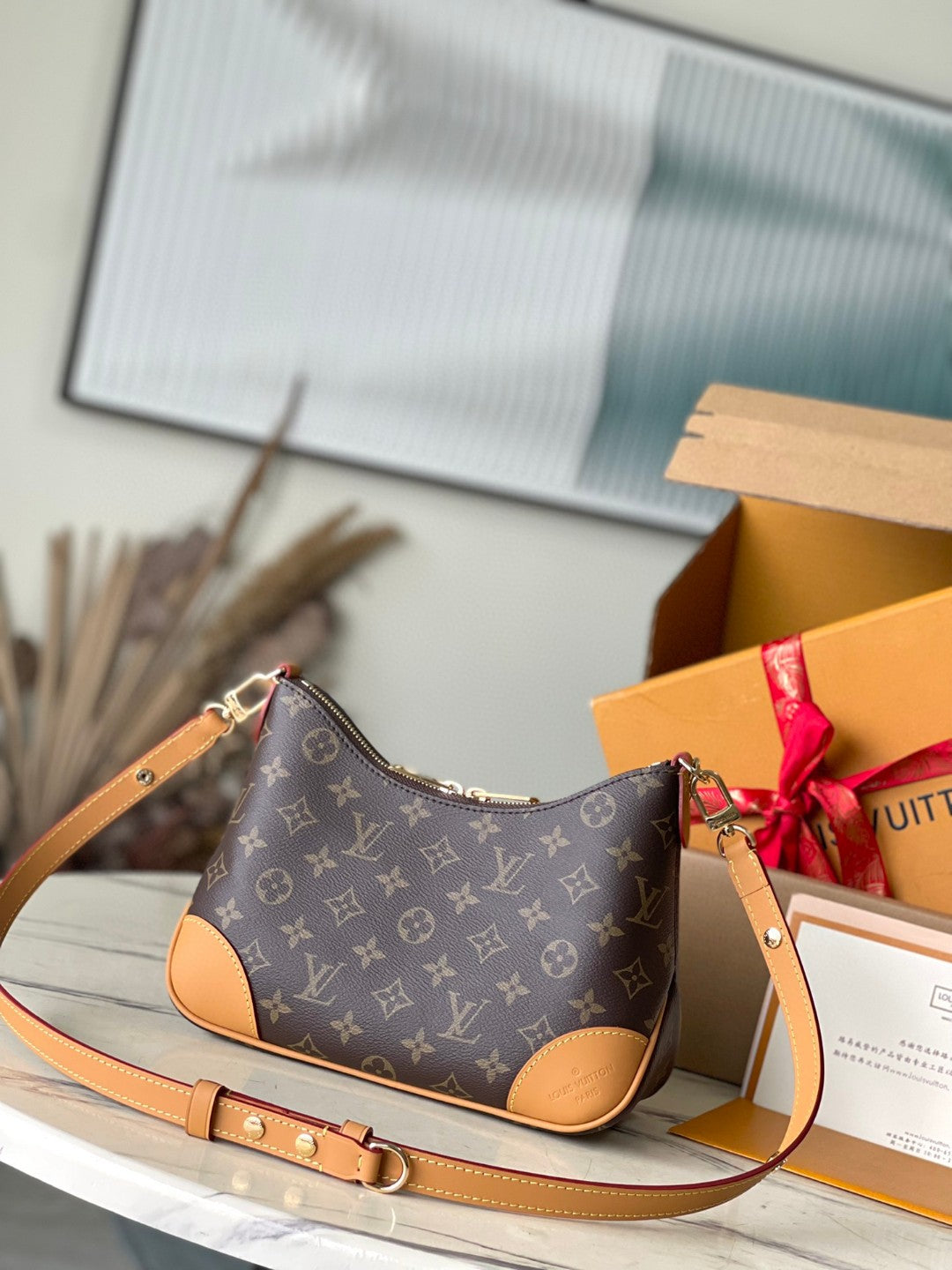 Louis Vuitton Boulogne PM bag in classic Monogram canvas with natural cowhide leather trim and gold-color hardware