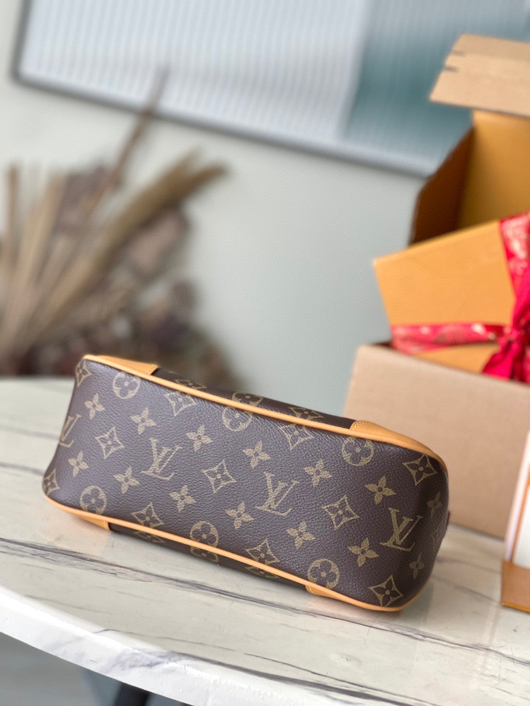 Louis Vuitton Boulogne PM bag in classic Monogram canvas with natural cowhide leather trim and gold-color hardware