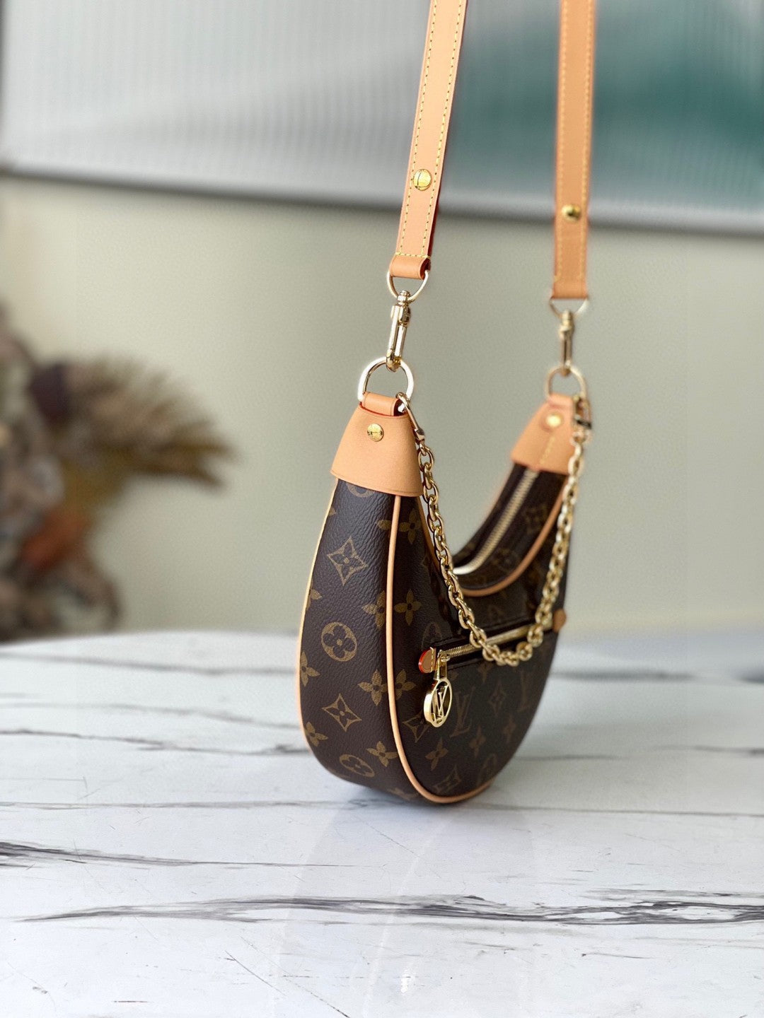 Louis Vuitton Loop handbag in Monogram brown coated canvas with natural cowhide leather trim and gold-tone hardware