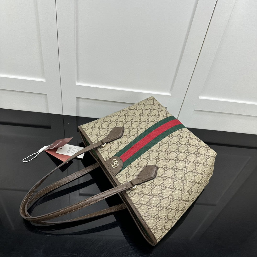 Gucci Ophidia GG medium tote bag crafted from GG Supreme canvas with brown leather trim and the signature green and red Web stripe