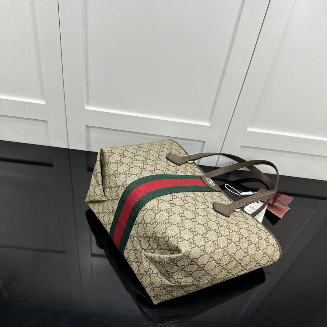 Gucci Ophidia GG medium tote bag crafted from GG Supreme canvas with brown leather trim and the signature green and red Web stripe