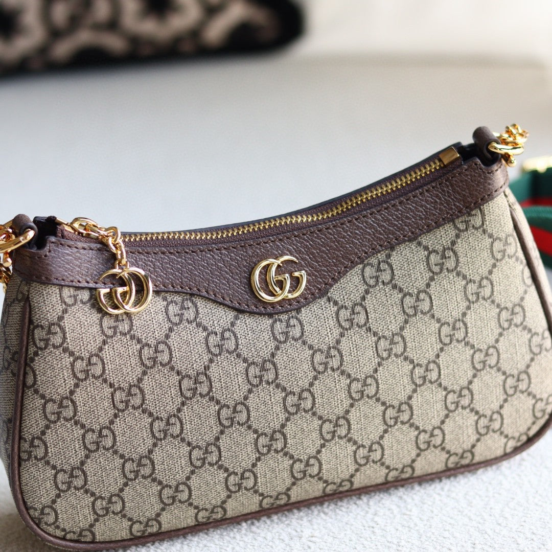 Gucci Ophidia GG small shoulder bag in GG Supreme canvas with brown leather trim, gold-toned hardware, and a red and green Web stripe