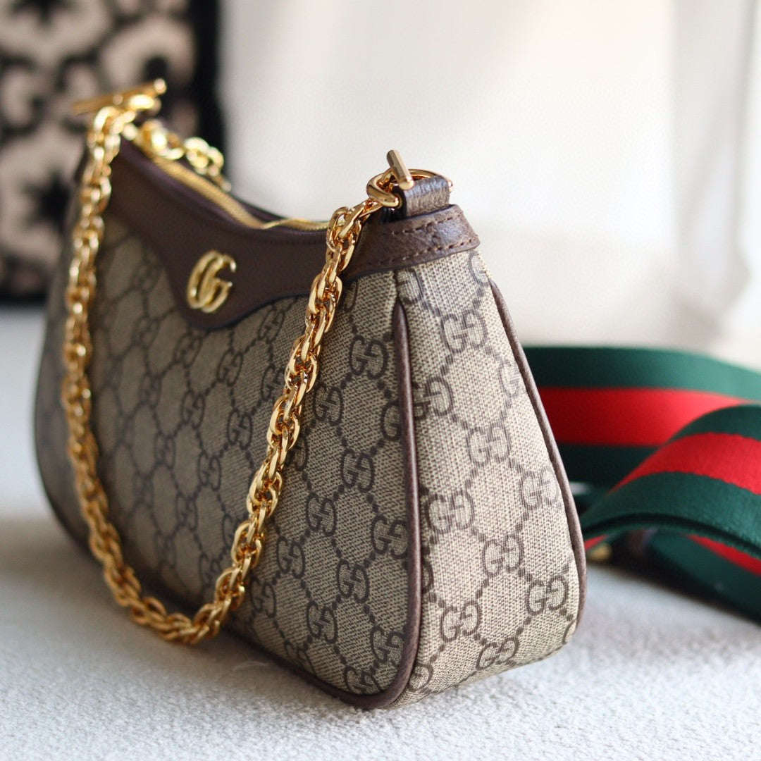 Gucci Ophidia GG small shoulder bag in GG Supreme canvas with brown leather trim, gold-toned hardware, and a red and green Web stripe