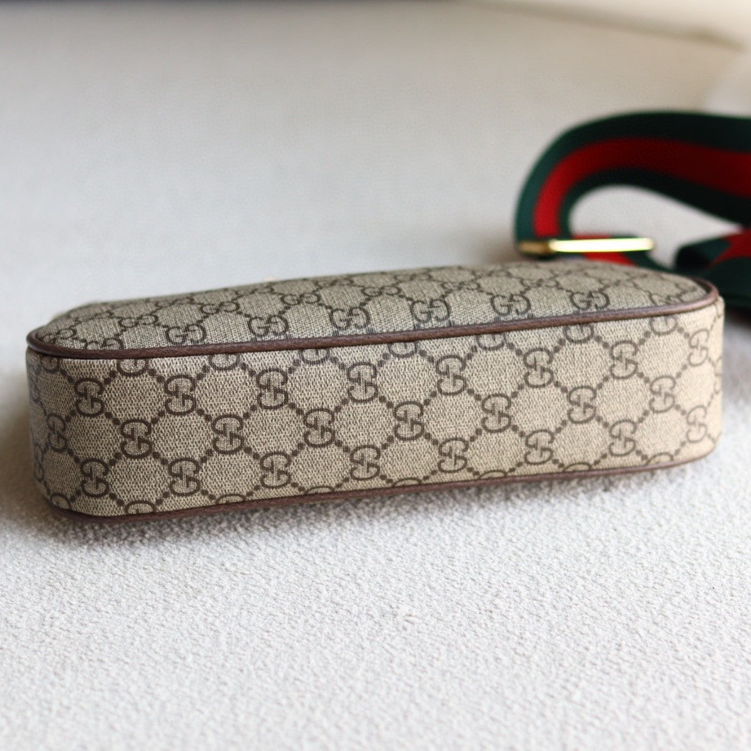 Gucci Ophidia GG small shoulder bag in GG Supreme canvas with brown leather trim, gold-toned hardware, and a red and green Web stripe