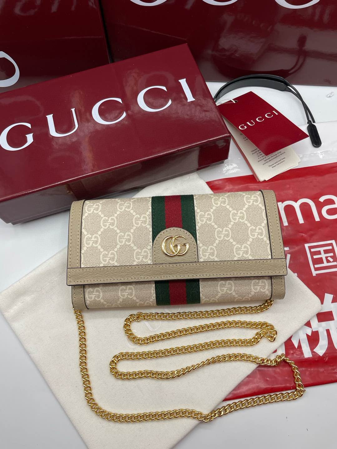 Gucci Ophidia chain wallet in beige/ebony GG Supreme canvas with brown leather trim and a green and red Web stripe