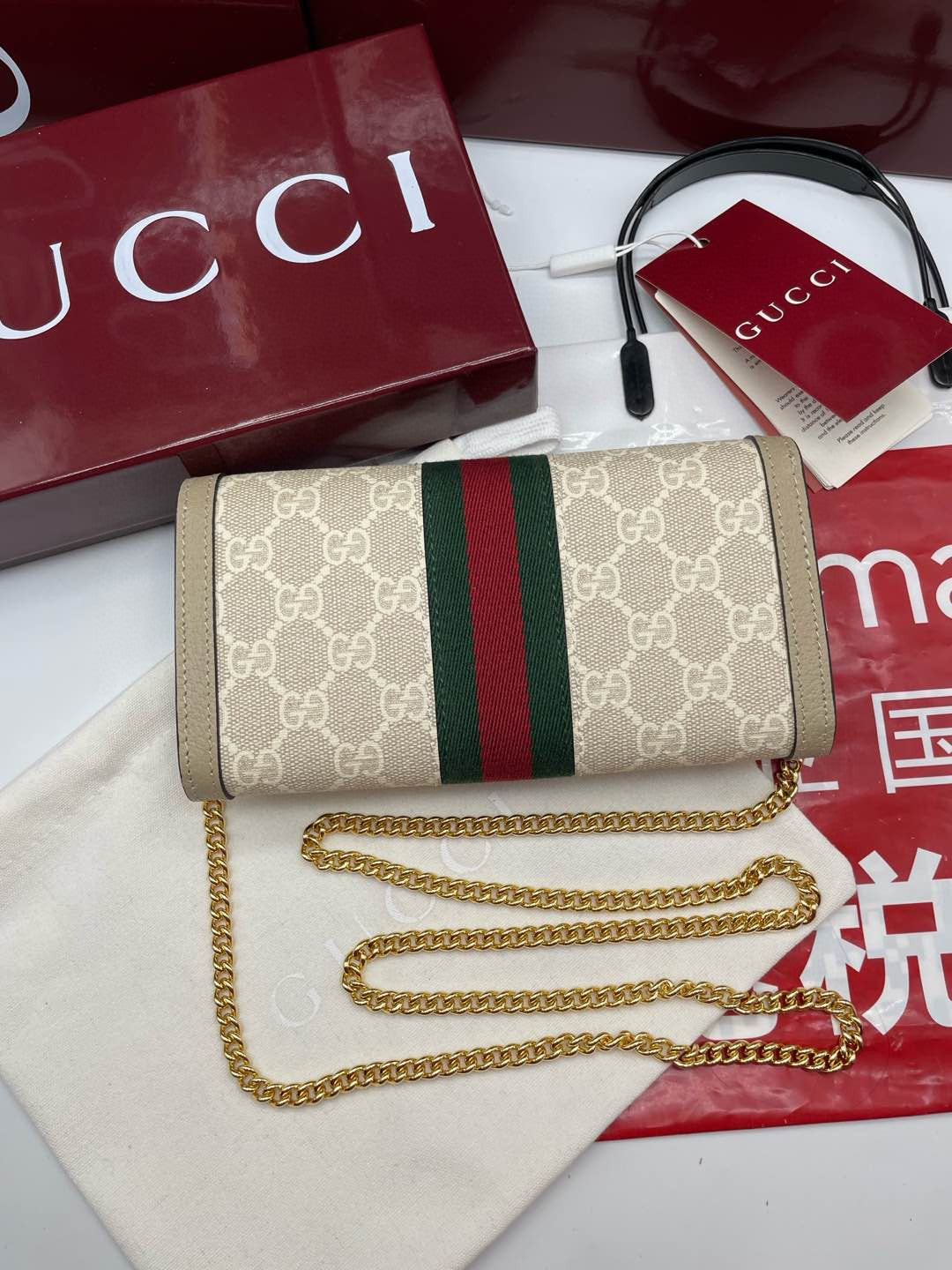 Gucci Ophidia chain wallet in beige/ebony GG Supreme canvas with brown leather trim and a green and red Web stripe