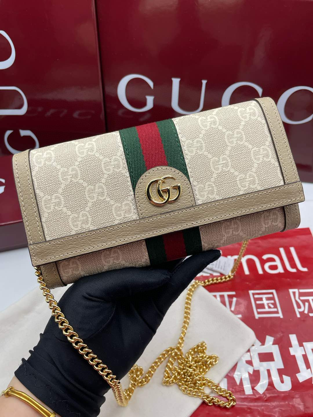 Gucci Ophidia chain wallet in beige/ebony GG Supreme canvas with brown leather trim and a green and red Web stripe