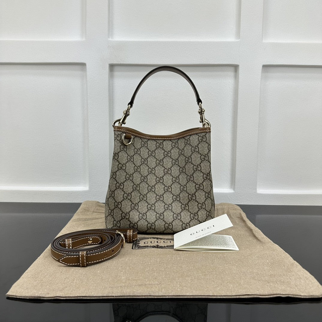 Gucci GG Emblem Small bucket bag in beige and ebony coated canvas with brown leather trim