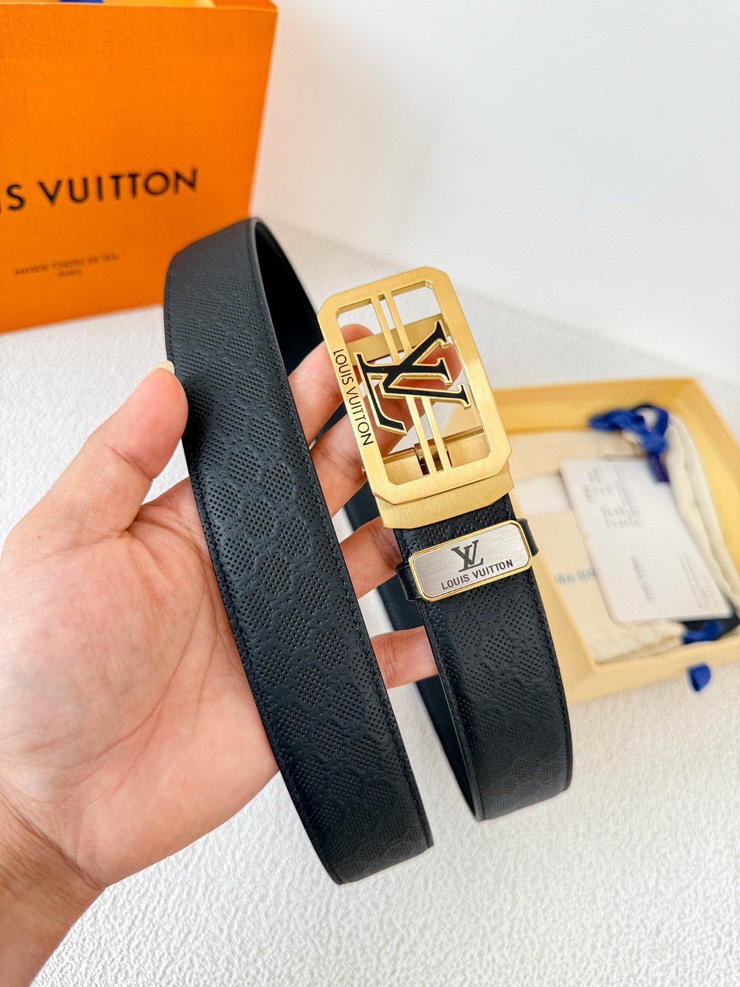 Louis Vuitton reversible leather belt with a gold LV logo buckle