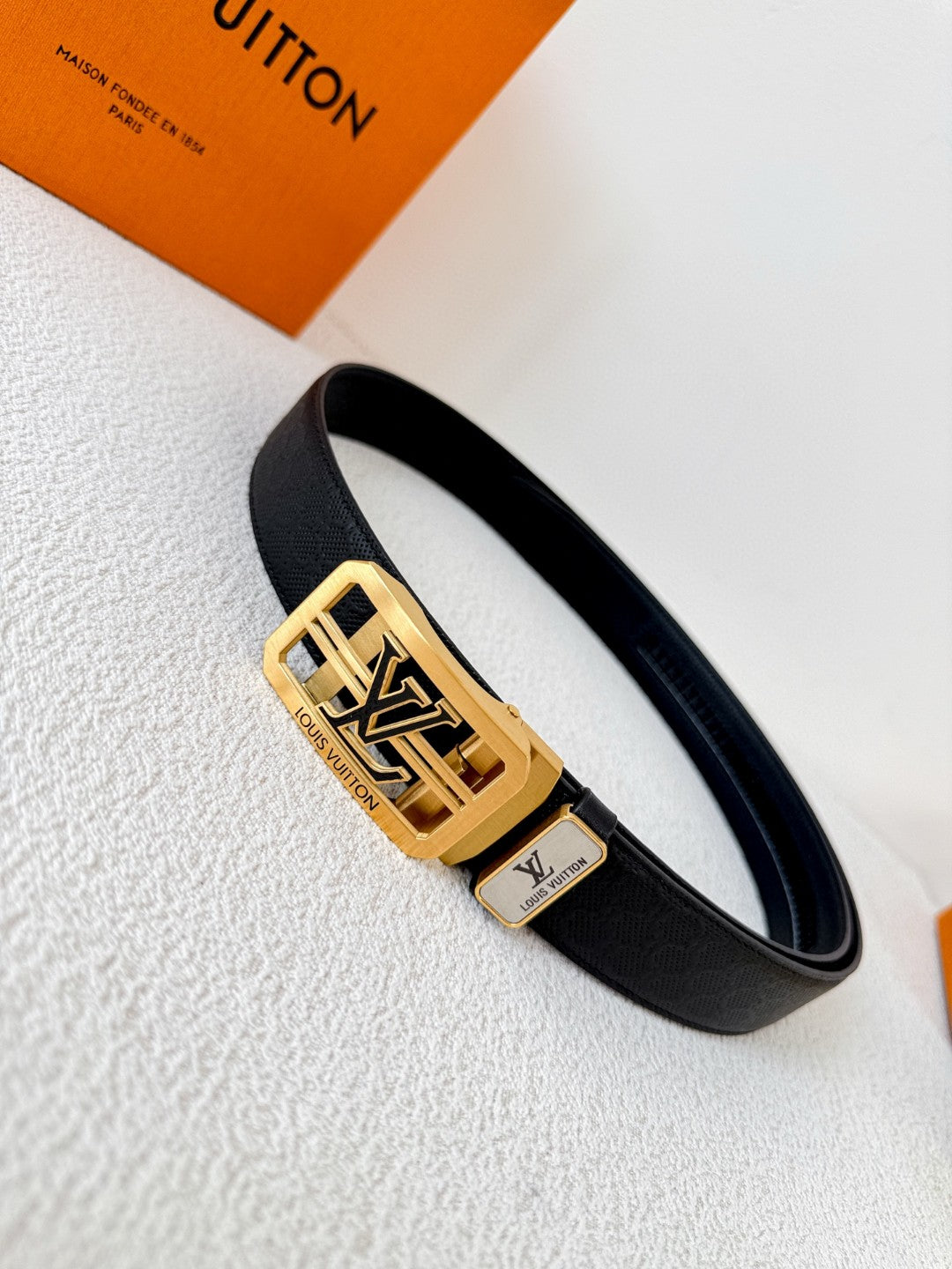 Louis Vuitton reversible leather belt with a gold LV logo buckle