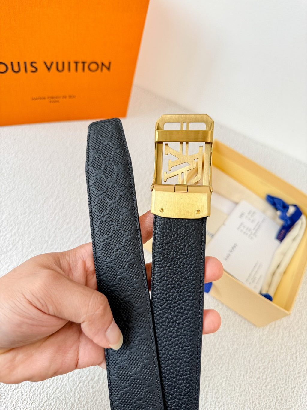 Louis Vuitton reversible leather belt with a gold LV logo buckle