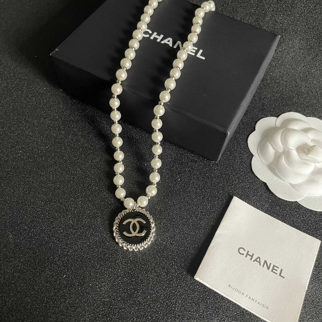 Chanel pearl necklace featuring the iconic double C logo charm