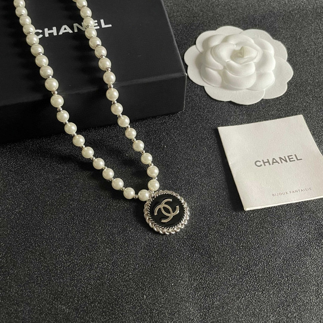 Chanel pearl necklace featuring the iconic double C logo charm