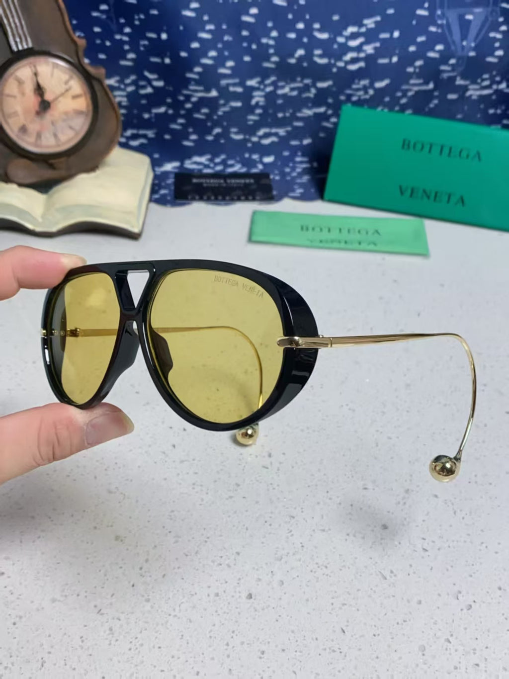 Bottega Veneta BV1273S Drop Aviator sunglasses with a black frame and yellow lenses