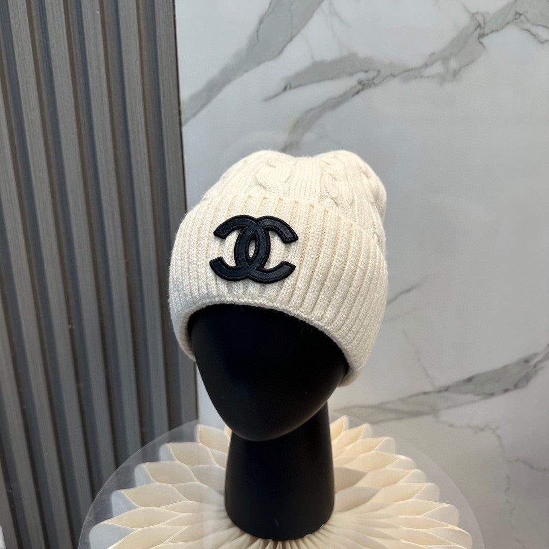 Chanel knit beanie in white with a black CC logo
