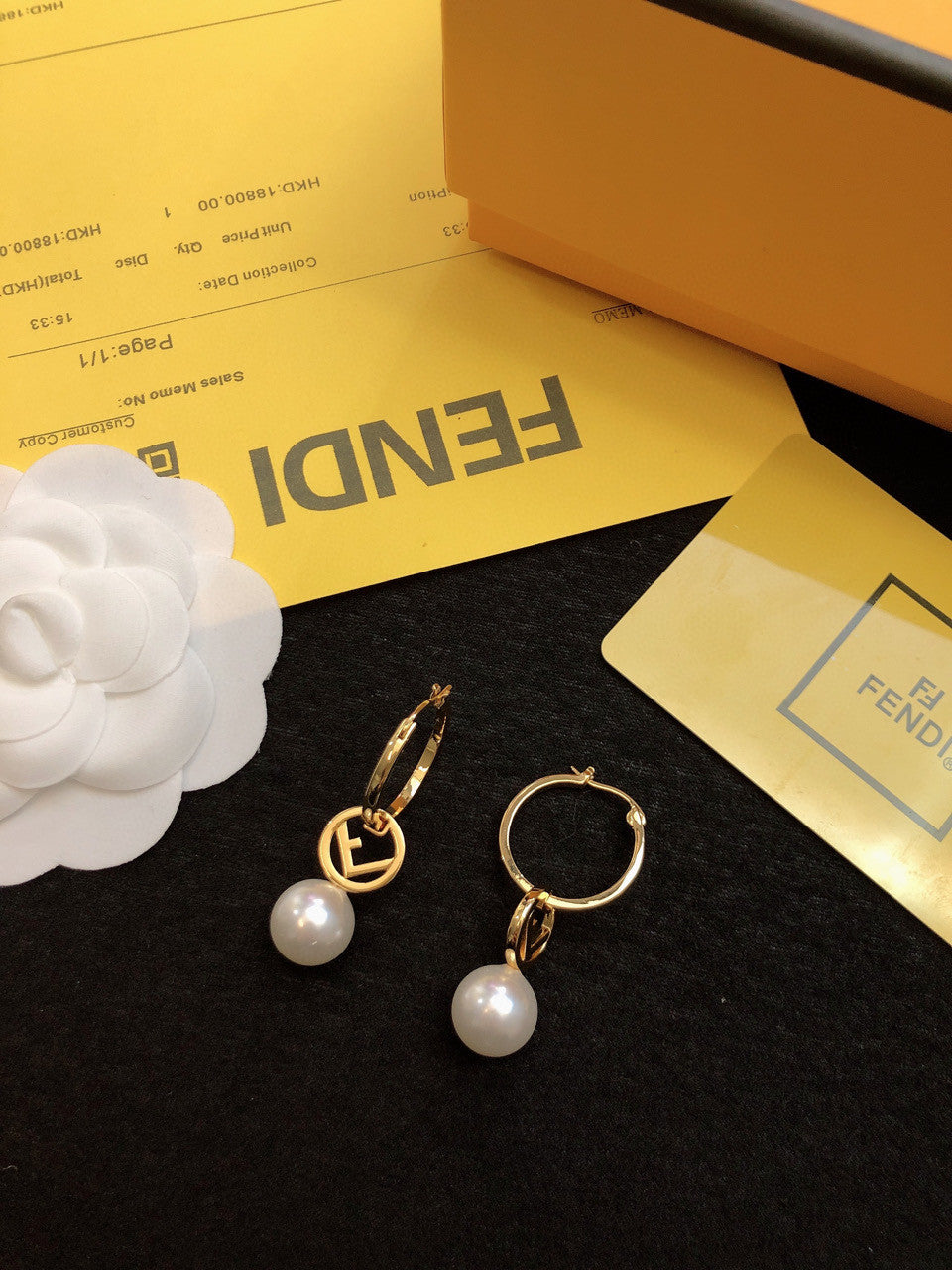 Fendi "F Is Fendi" hoop earrings in a gold-tone finish with a faux pearl drop