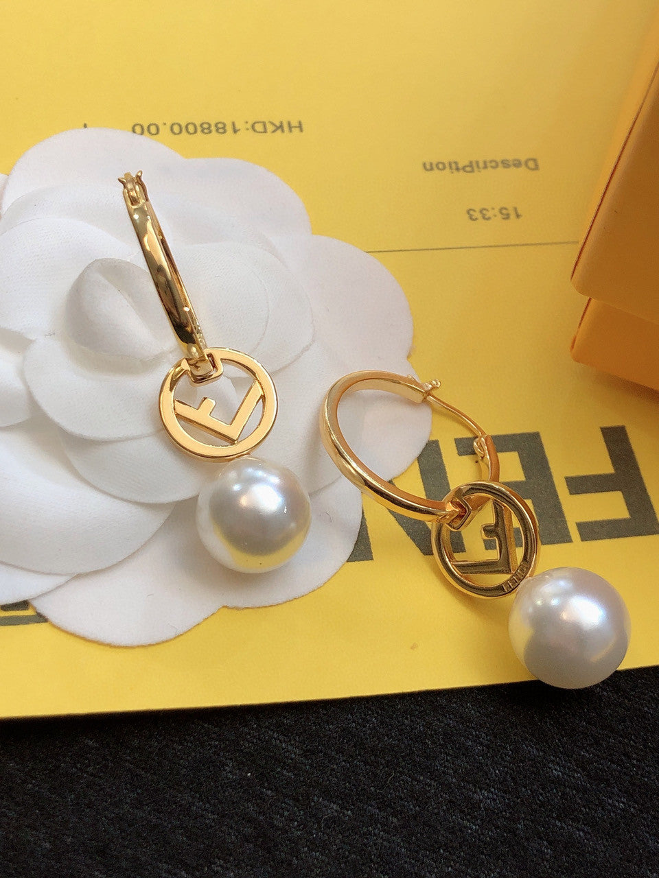 Fendi "F Is Fendi" hoop earrings in a gold-tone finish with a faux pearl drop