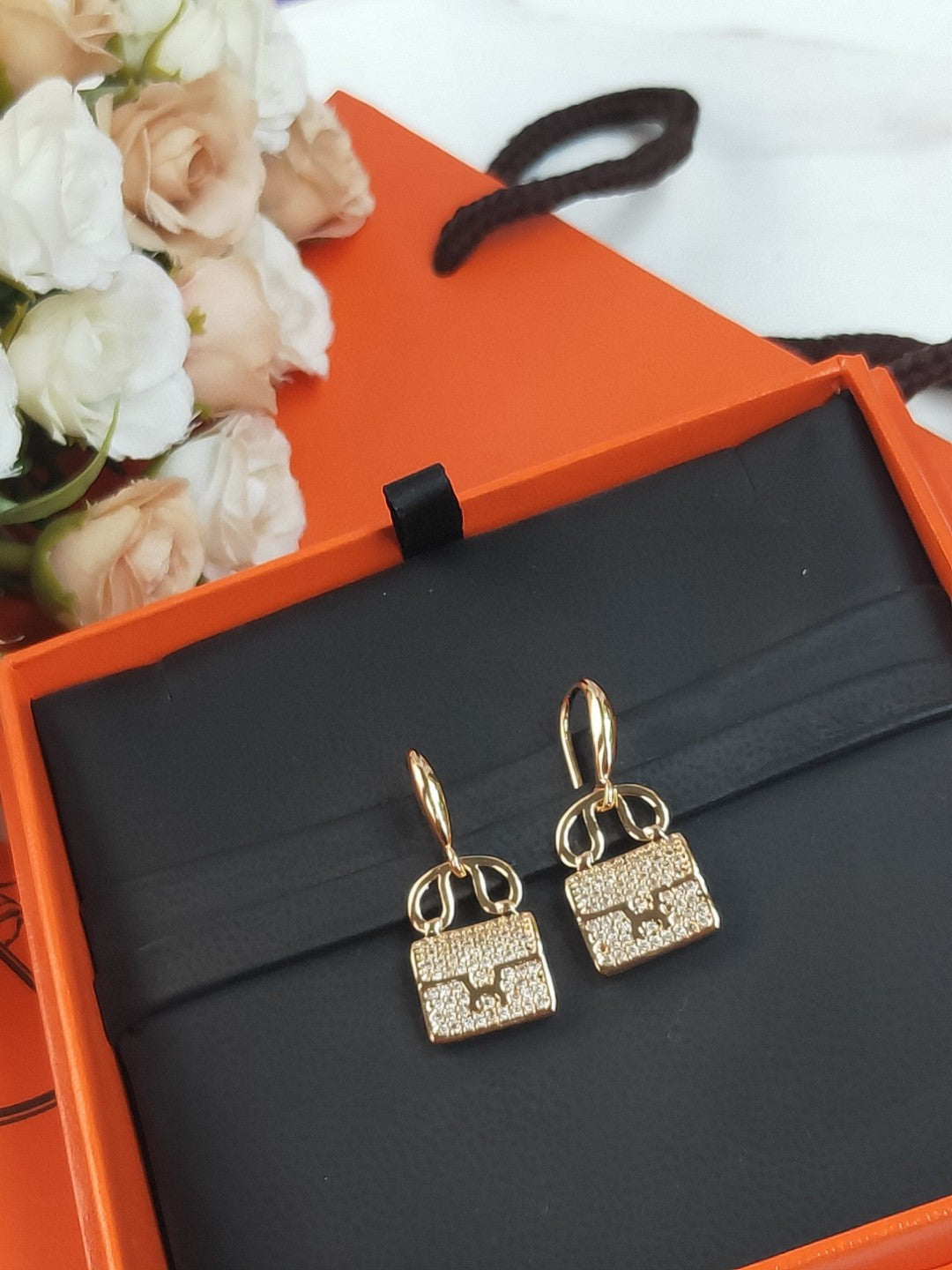 Hermès Amulettes Constance earrings in rose gold with diamond accents