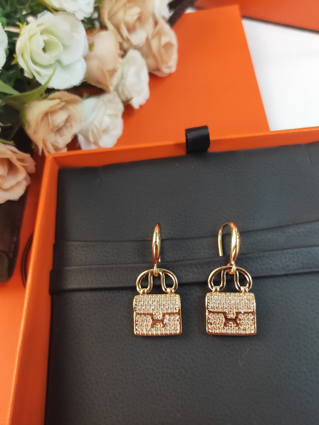 Hermès Amulettes Constance earrings in rose gold with diamond accents