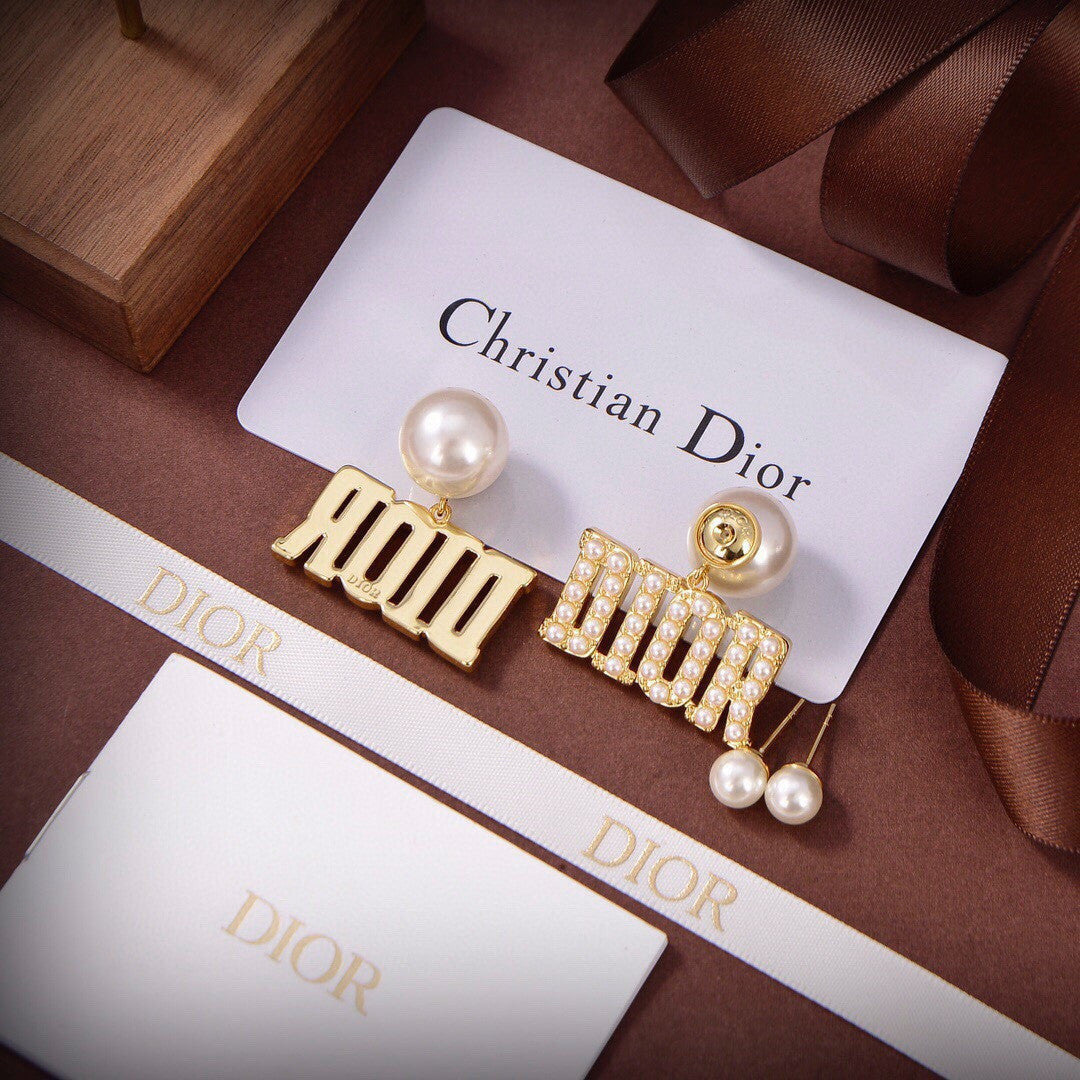 Dior Tribales earrings featuring white resin pearls and gold-finish metal D.I.O.R. letters